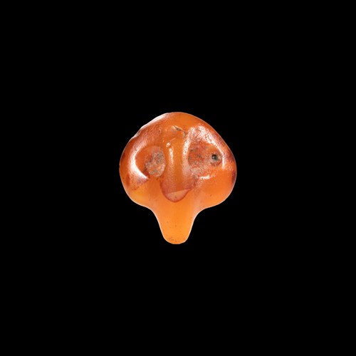 A rare Predynastic carnelian 'Bull's head' pendant amulet.